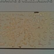 Fragment of the Fasti Antiates, an ancient Roman calendar painted on plaster, showing month names, festival markings, and preserved red and black inscriptions.